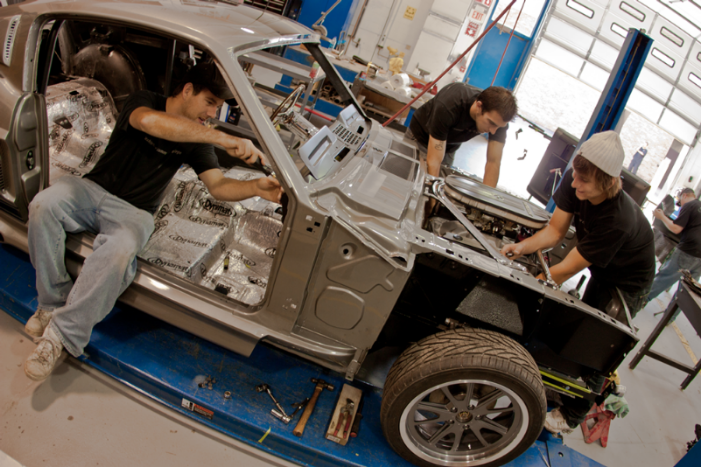 automotive students working on a car