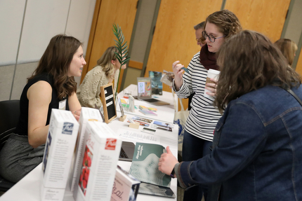 Graphic design student Mary Huotari shows her portfolio May 2 at the annual Digital Media Arts Student Gala.