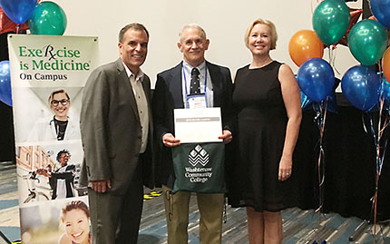 WCC faculty member Dr. Marvin Boluyt (center) receives the college's silver recognition from Dr. Robert Sallis and Dr. Renee Jeffries-Heil of the American College of Sports Medicine.