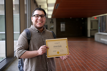 WCC student Ahmed Ghalib with a certificate signifying his selection as a Jack Kent Cooke Foundation Undergraduate Transfer Scholarship recipient.