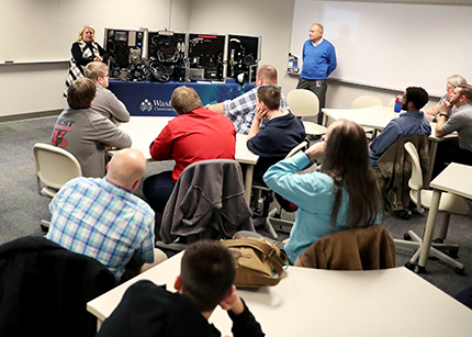 High school students listen to WCC faculty Cyndi Millns and Michael Galea discuss the importance of cybersecurity Nov. 12 at Square One's Autonomous Innovative Vehicle Design program, which kicked off earlier in the day.