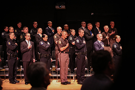 The WCC Police Academy Class of 2019 recites the Pledge of Allegiance before Friday's graduation ceremony.
